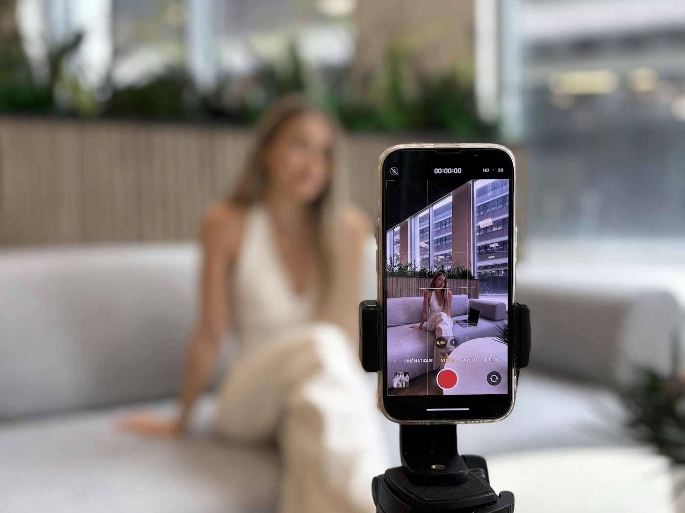 Creator recording video content with a smartphone on a tripod