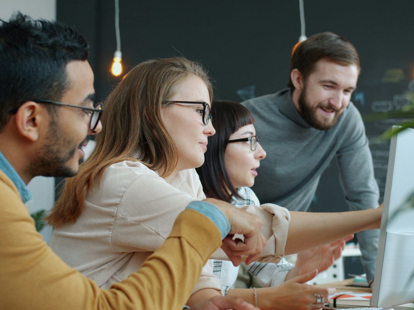 Marketing team reviewing campaign data together on a computer screen